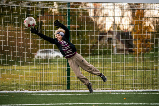 Boy goalkeeper ready to save a ball during a soccer match.