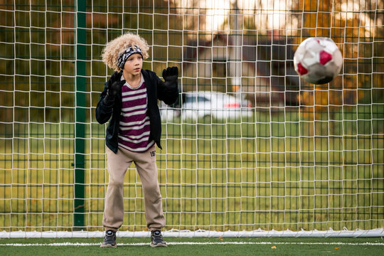 Boy goalkeeper ready to save a ball during a soccer match.