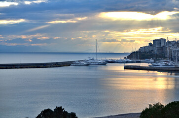 Golden hour sunset over Zea Marina with yachts in Piraeus