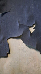 Wall with peeling and damaged black paint surface