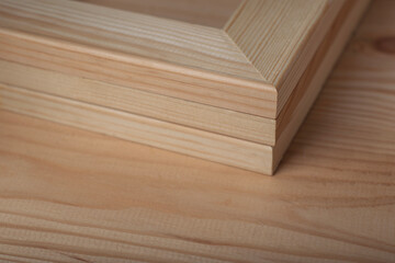 Three wooden stretcher frames on textured wooden table