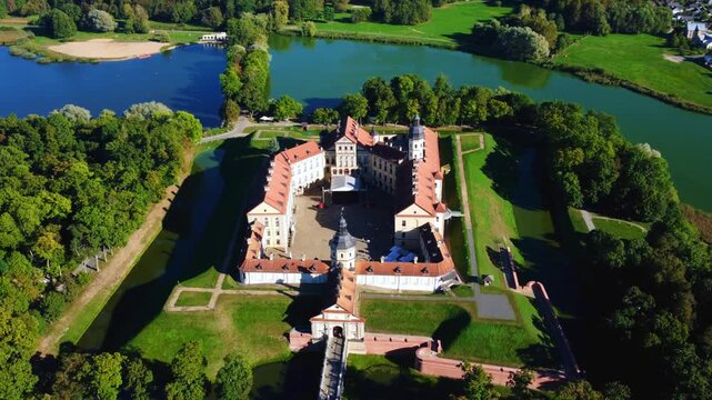 Nesvizh Castle - a top view of a medieval castle in autumn, Belarus. A landscape with a palace surrounded by a moat on a sunny autumn day. The Radziwill Family Castle from a bird's-eye view. 4К