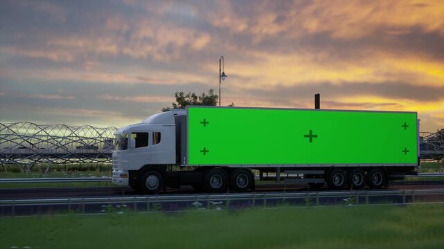 White Semi Truck Driving on Highway at Sunset with Green Screen Trailer for Advertisement Mockup
