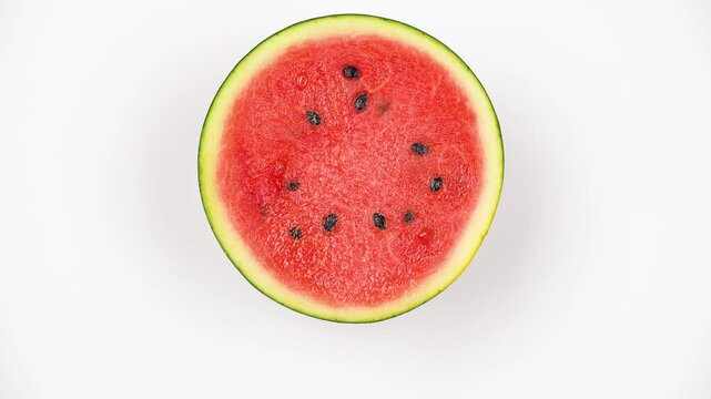 Macro texture of rotating fresh watermelon flesh. Red fruit pulp background with seeds.
