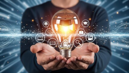 Illuminated and dynamic conceptual photograph of a person’s cupped hands gently presenting a glowing lightbulb filled with miniature graduation caps and digital icons, set against a blurred,