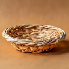 Obraz premium A detailed close up of an empty woven round basket with a visibly textured rim, set against a plain brown background with gentle lighting.