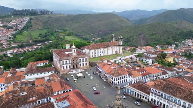 Ouro Preto, Brazil: Aerial drone footage of Tiradente Square in Ouro Preto, old town of Brazil with the museum in the center. Taken with backward motion showing the mountain in the background