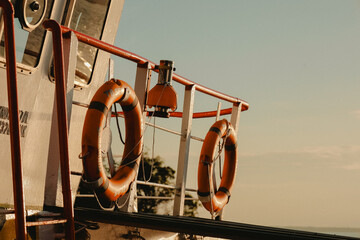 Nautical Focused View of Lifebuoys on a Ship at Sunset Light