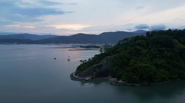 Paraty, Brazil: Paraty, Brazil: Aerial footage revealing the Paraty coastal area, an old town town in Rio de Janeiro, Brazil during dramatic sunset with mountain of the Coasta Verde in the background