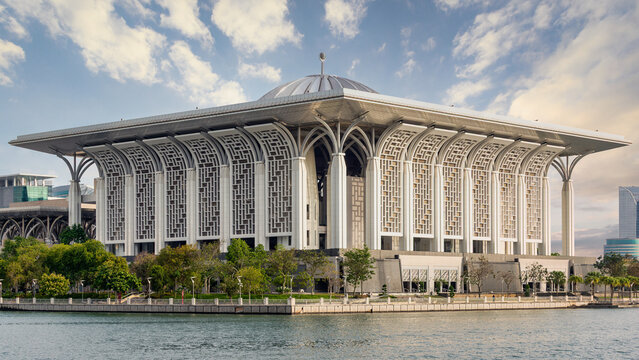 Putrajaya, Malaysia - Feb. 20, 2025: Tuanku Mizan Zainal Abidin Mosque, aka Iron Mosque. Modern Islamic architecture by the lake under a cloudy sky