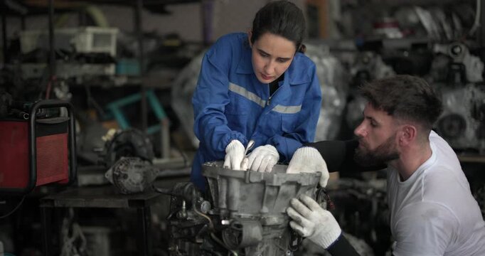 Auto mechanic disassemble mechanical engine components for diagnosis, troubleshooting in automotive workshop. Technical expertise, precision required in field of vehicle repair and maintenance.
