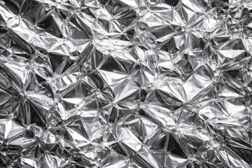 Crumpled silver aluminium foil texture background