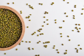 Green mung beans in wooden bowl isolated on white background with copy space. Organic dried legumes...