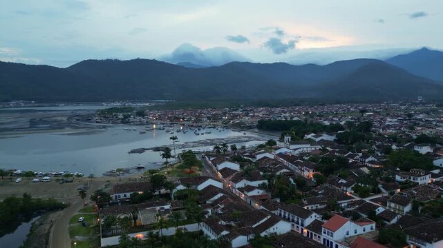 Paraty, Brazil: Aerial drone footage of Paraty, an old town in state of Rio de Janeiro, Brazil. WIth orbit motion showing the waterfront church and porto paraty on cloudy sunset