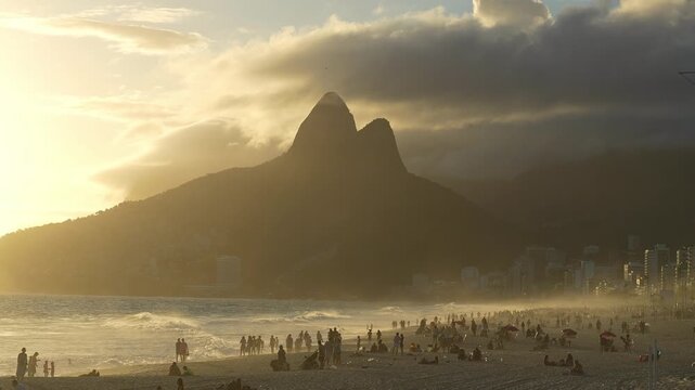 Rio de Janeiro, Brazil: Footage of people enjoying sunset in Ipenema beach, Rio de Janeiro, Brazil with dramatic sky above Two Brothers Mountain