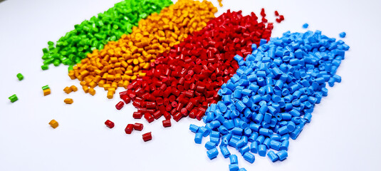 Colorful polymer plastic masterbatch pellets arranged by shade, showcasing high-quality additives used to enhance color, stability, and performance in plastic manufacturing processes efficiently