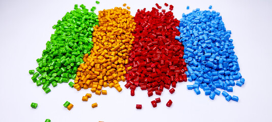 Colorful polymer plastic masterbatch pellets arranged by shade, showcasing high-quality additives used to enhance color, stability, and performance in plastic manufacturing processes efficiently