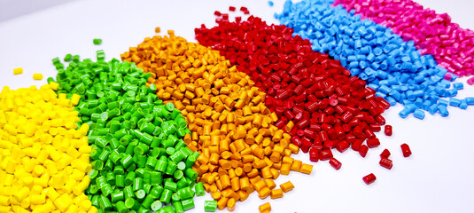 Colorful polymer plastic masterbatch pellets arranged by shade, showcasing high-quality additives used to enhance color, stability, and performance in plastic manufacturing processes efficiently.	