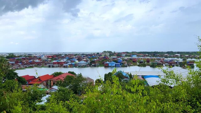Viewpoint of a flooded fishing village near the Krahom Temple, Cambodia. From the mountain Krahom (Pnom Krom) overlooking the lake Tonlesap. Houses are built on high stilts. Rainy season. 4К
