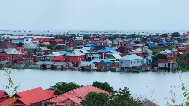 Viewpoint of a flooded fishing village near the Krahom Temple, Cambodia. From the mountain Krahom (Pnom Krom) overlooking the lake Tonlesap. Houses are built on high stilts. Rainy season. 4К