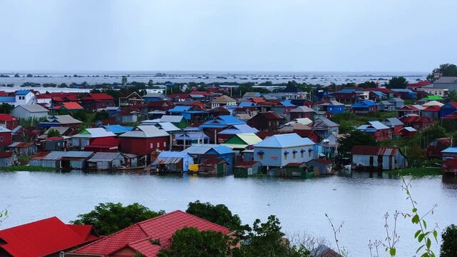 Viewpoint of a flooded fishing village near the Krahom Temple, Cambodia. From the mountain Krahom (Pnom Krom) overlooking the lake Tonlesap. Houses are built on high stilts. Rainy season. 4К