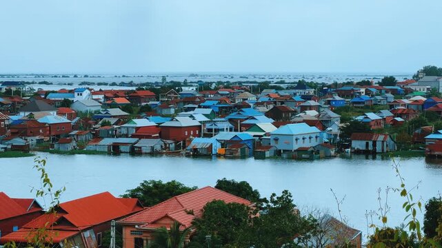 Viewpoint of a flooded fishing village near the Krahom Temple, Cambodia. From the mountain Krahom (Pnom Krom) overlooking the lake Tonlesap. Houses are built on high stilts. Rainy season. 4К