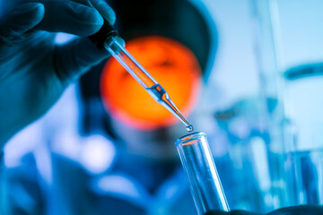 Scientist Using Pipette to Transfer Liquid Sample in Laboratory Research and Chemical Analysis