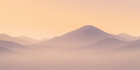 A vibrant mountain landscape at dawn reveals a glowing orange horizon as the sun rises over desert sand dunes and misty peaks under a summer sky © MDNUR