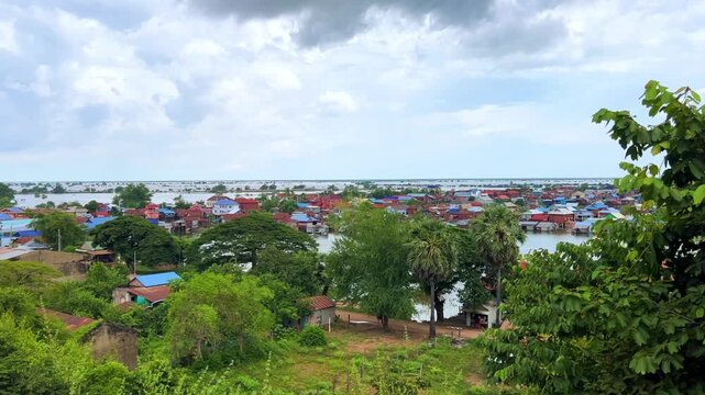 Viewpoint of a flooded fishing village near the Krahom Temple, Cambodia. From the mountain Krahom (Pnom Krom) overlooking the lake Tonlesap. Houses are built on high stilts. Rainy season. 4К