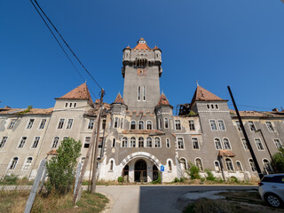 Derelict barracks with central tower and turrets in Hajmaskér, Hungary © Carismarkus