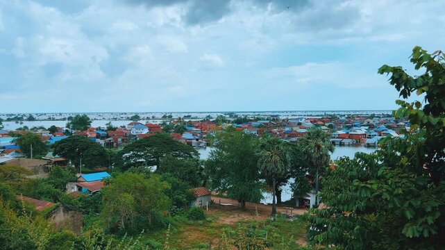 Viewpoint of a flooded fishing village near the Krahom Temple, Cambodia. From the mountain Krahom (Pnom Krom) overlooking the lake Tonlesap. Houses are built on high stilts. Rainy season. 4К