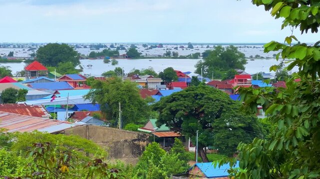 Viewpoint of a flooded fishing village near the Krahom Temple, Cambodia. From the mountain Krahom (Pnom Krom) overlooking the lake Tonlesap. Houses are built on high stilts. Rainy season. 4К