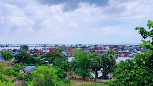 Viewpoint of a flooded fishing village near the Krahom Temple, Cambodia. From the mountain Krahom (Pnom Krom) overlooking the lake Tonlesap. Houses are built on high stilts. Rainy season. 4К