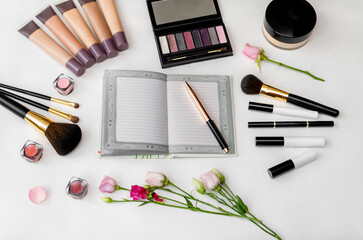 Cosmetics and accessories arranged on a white surface.