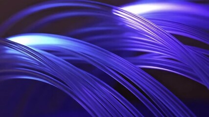 Vibrant blue and purple fiber optic cables in dynamic motion