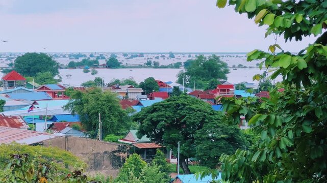 Viewpoint of a flooded fishing village near the Krahom Temple, Cambodia. From the mountain Krahom (Pnom Krom) overlooking the lake Tonlesap. Houses are built on high stilts. Rainy season. 4К