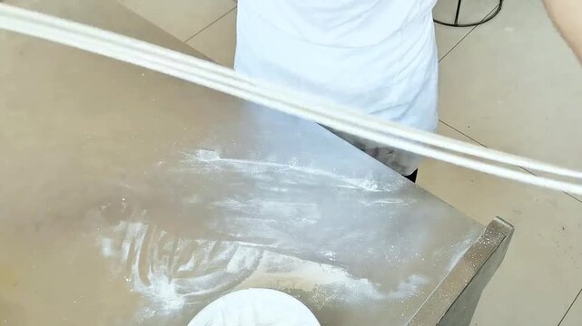 The chef is making Chinese hand-pulled noodles