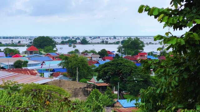 Viewpoint of a flooded fishing village near the Krahom Temple, Cambodia. From the mountain Krahom (Pnom Krom) overlooking the lake Tonlesap. Houses are built on high stilts. Rainy season. 4К