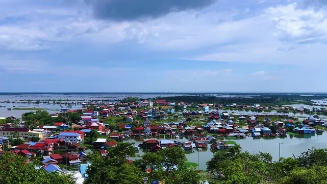 Viewpoint of a flooded fishing village near the Krahom Temple, Cambodia. From the mountain Krahom (Pnom Krom) overlooking the lake Tonlesap. Houses are built on high stilts. Rainy season. 4К
