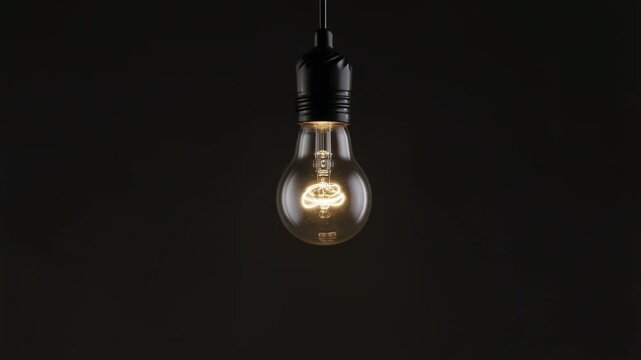 Illuminating edison light bulb transition with vibrant glow changes in darkness