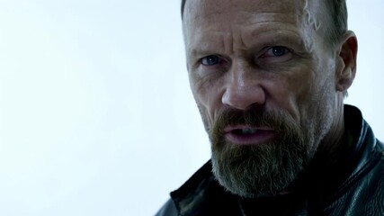 Intense facial expressions and closeups of bearded man in dramatic lighting