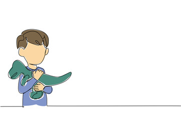 Single continuous line drawing a boy hugs a t-rex dinosaur doll and puts it on his chest. Plays with favorite doll. Playing learning about animals. Dinosaur Day. One line design vector illustration © Simple Line