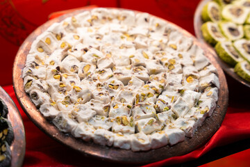Close-up of another type of Turkish sweet, showcasing syrup, nuts, and pastry textures. Traditional confectionery detail.


