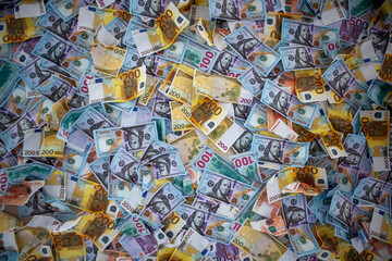 Collection of colorful banknotes scattered across a surface showcasing various denominations and designs