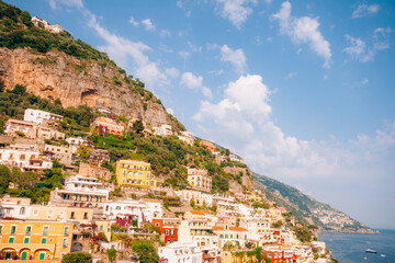 Colorful houses cling to a steep cliff overlooking the sea in Positano Italy