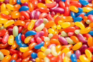 Close-up texture of a pile of green candies. Vibrant color and sugary surface details.

