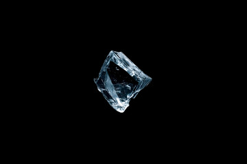 ice crystal isolated on a pure black background showcasing its brilliant clarity and multifaceted structure, perfect for visual projects requiring stunning frozen imagery