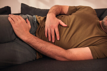 Man with gastritis, chest, stomach and abdominal pain at home.