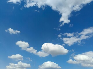 Bright Blue Sky with White Clouds and Sunlight