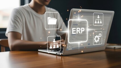 Enterprise Resource Planning: Employee Using Laptop with ERP Interface for Business Process Integration